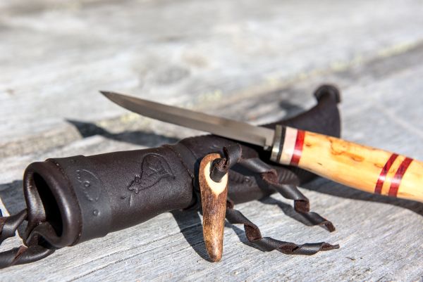 Knife with wooden handle and leather sheath