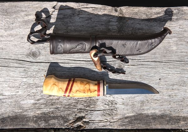Knife with wooden handle and leather sheath