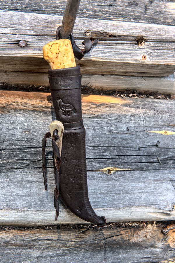 Knife with wooden handle and leather sheath