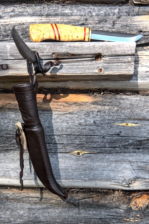 Knife with wooden handle and leather sheath