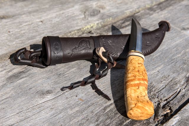 Knife with wooden handle and leather sheath