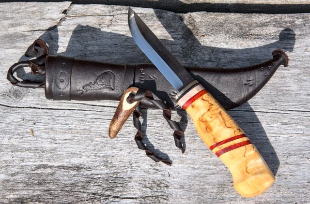 Knife with wooden handle and leather sheath
