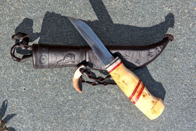 Knife with wooden handle and leather sheath