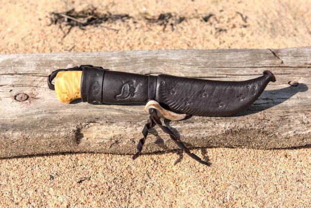 Knife with wooden handle and leather sheath