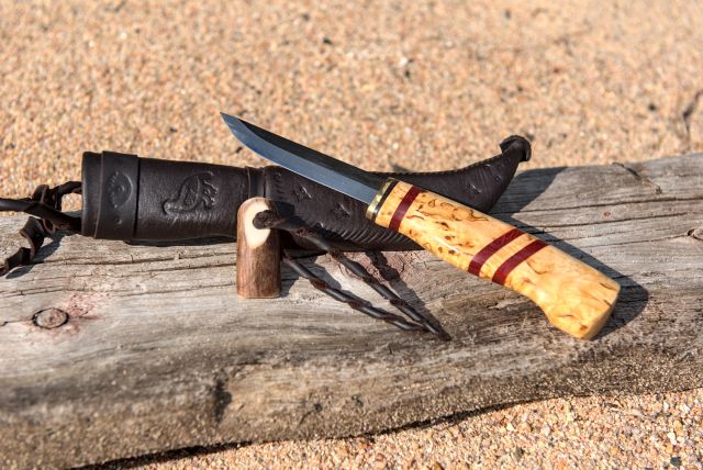 Knife with wooden handle and leather sheath