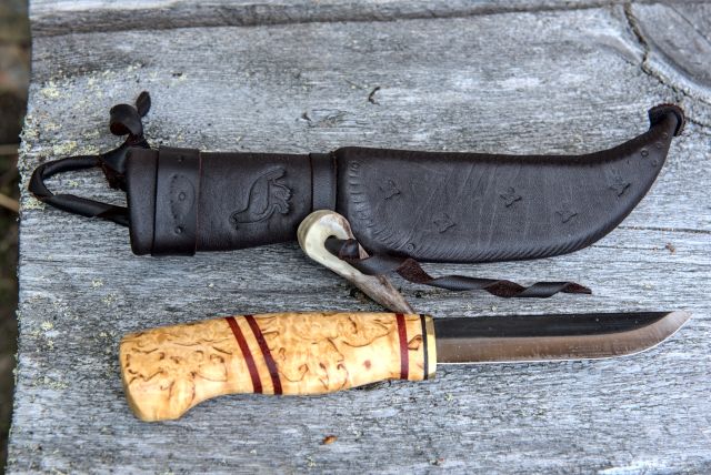 Knife with wooden handle and leather sheath