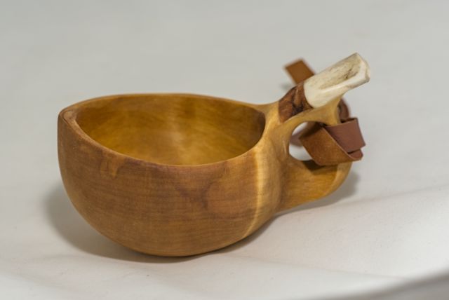 wooden cup with leather strap